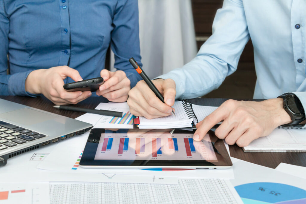 two people work from a tablet discussing managed IT services